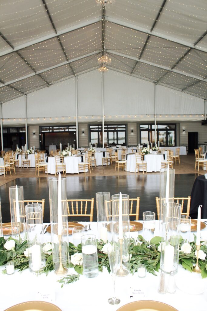 The Pavilion set with gold chairs and low greenery centerpieces